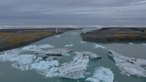 Jökulsárlón-bridge-crossing-lagoon-with-sea-in-background,-Iceland