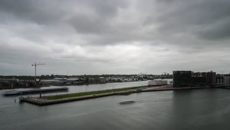 timelapse video of boat traffic on the ij river in amsterdam, during a cloudy day in autumn season