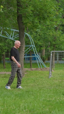 grandfather, father, and son share a bonding moment as they play football together, the grandfather passes the ball to his grandson, who kicks it towards his father