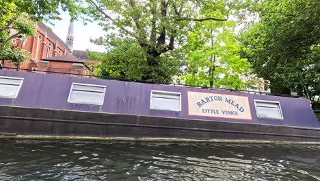 narrowboat moving along camden canal in london