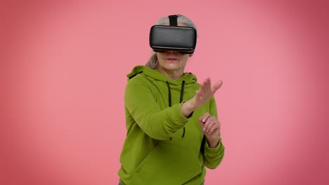 Elderly-woman-using-virtual-reality-VR-app-headset-helmet-to-play-simulation-3D-video-game-drawing