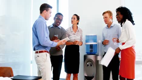 executives discussing over digital tablet