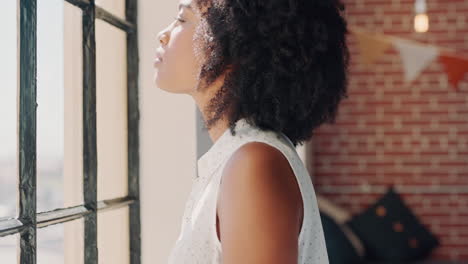 thinking black woman at office window planning