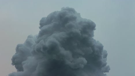 white cloud of smoke rises to sky