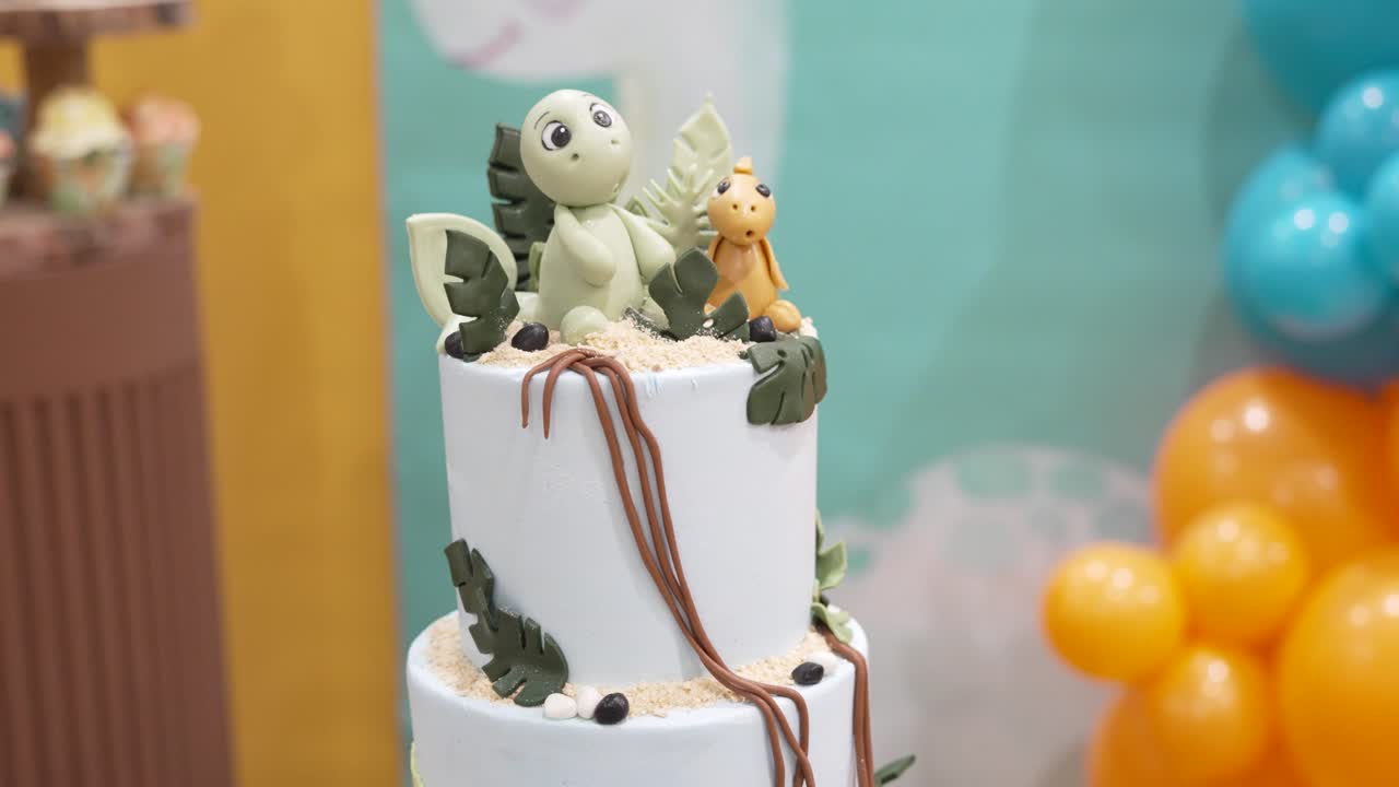 Unique dinosaur-themed cake decoration with cute figures and vibrant colors for a special celebration