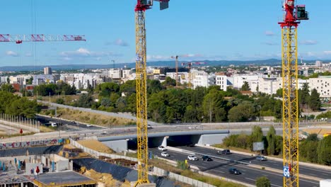 aerial shot of cranes working at developing the odysseum tramway in france