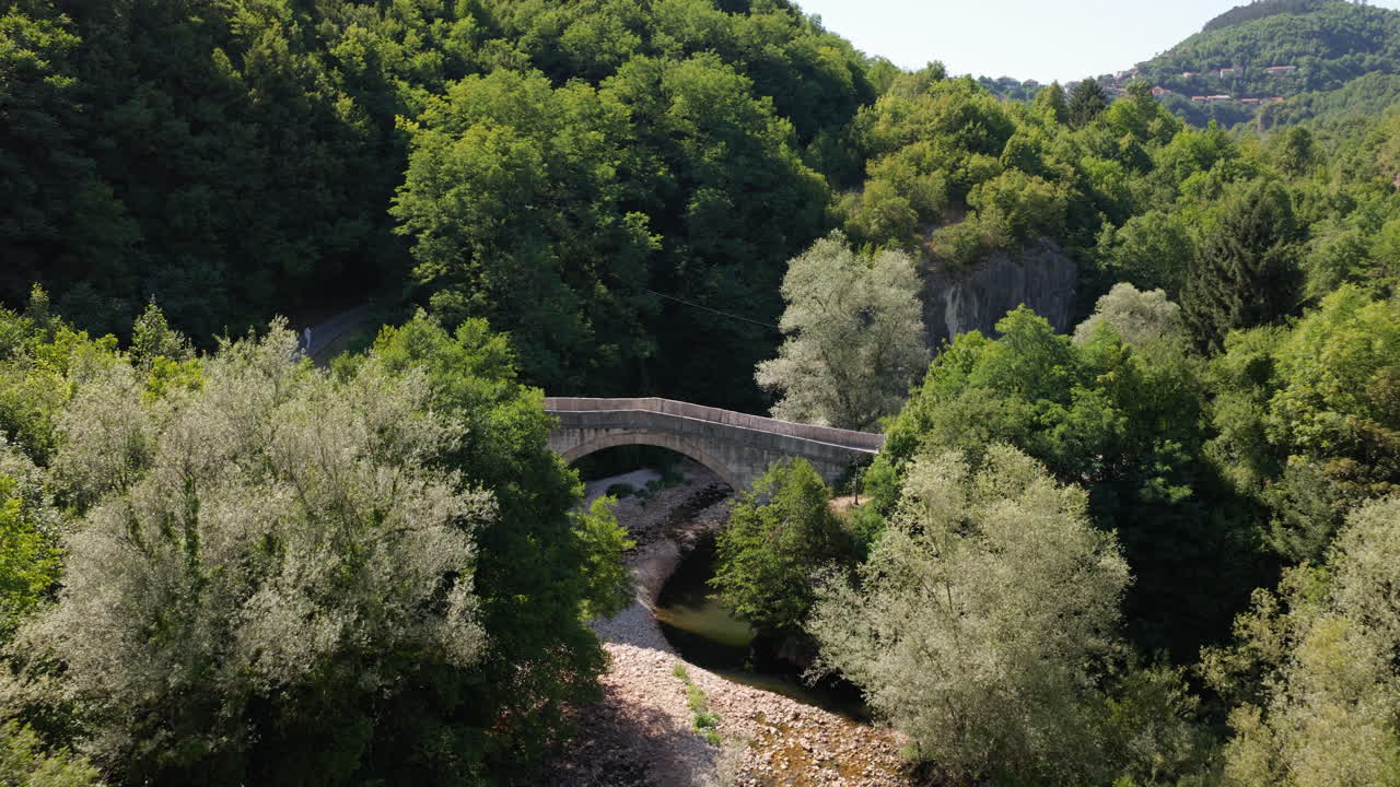 Historic Goat's Stone Bridge Crossing The Miljacka River In Sarajevo, Bosnia and Herzegovina. Aerial Drone Shot