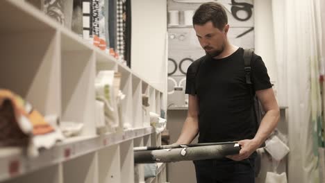 man shopping for fabrics in a home decor store