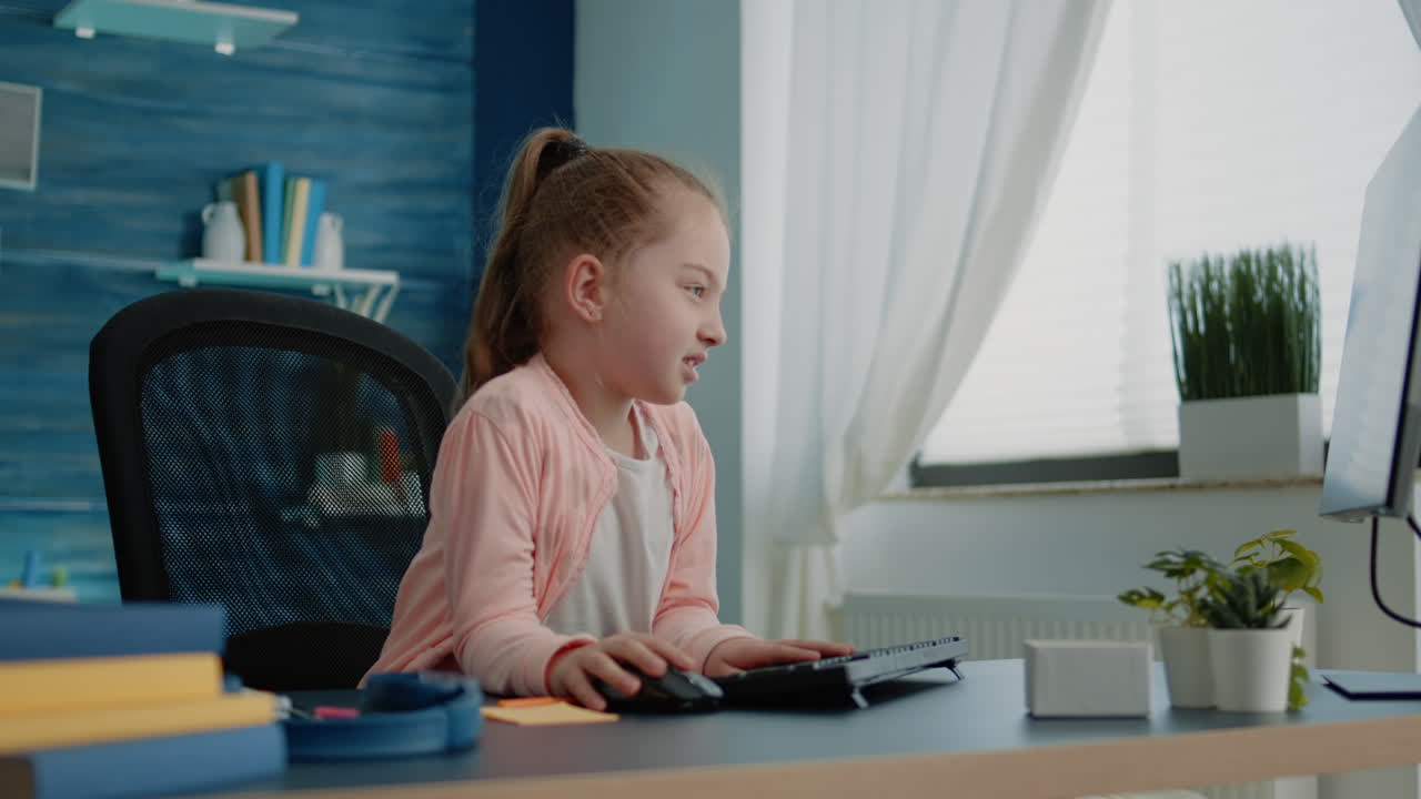 Frustrated child using computer and keyboard for homework