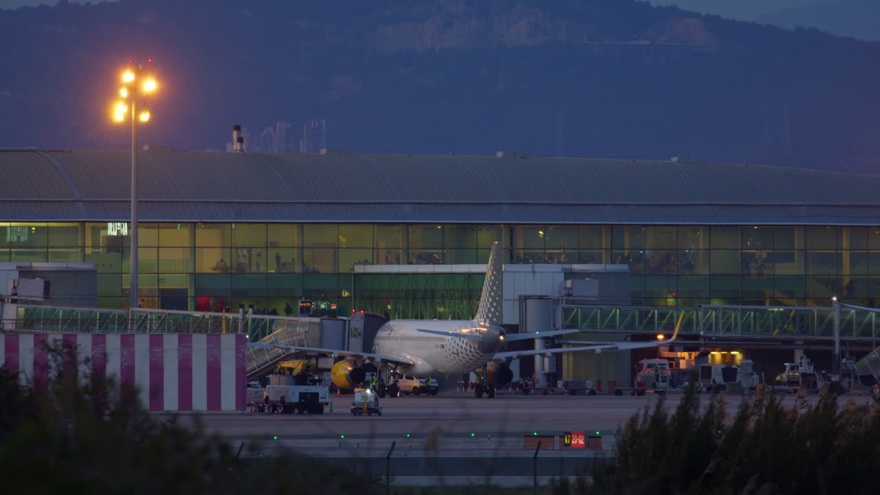 Airplane at Airport Terminal at Sunset