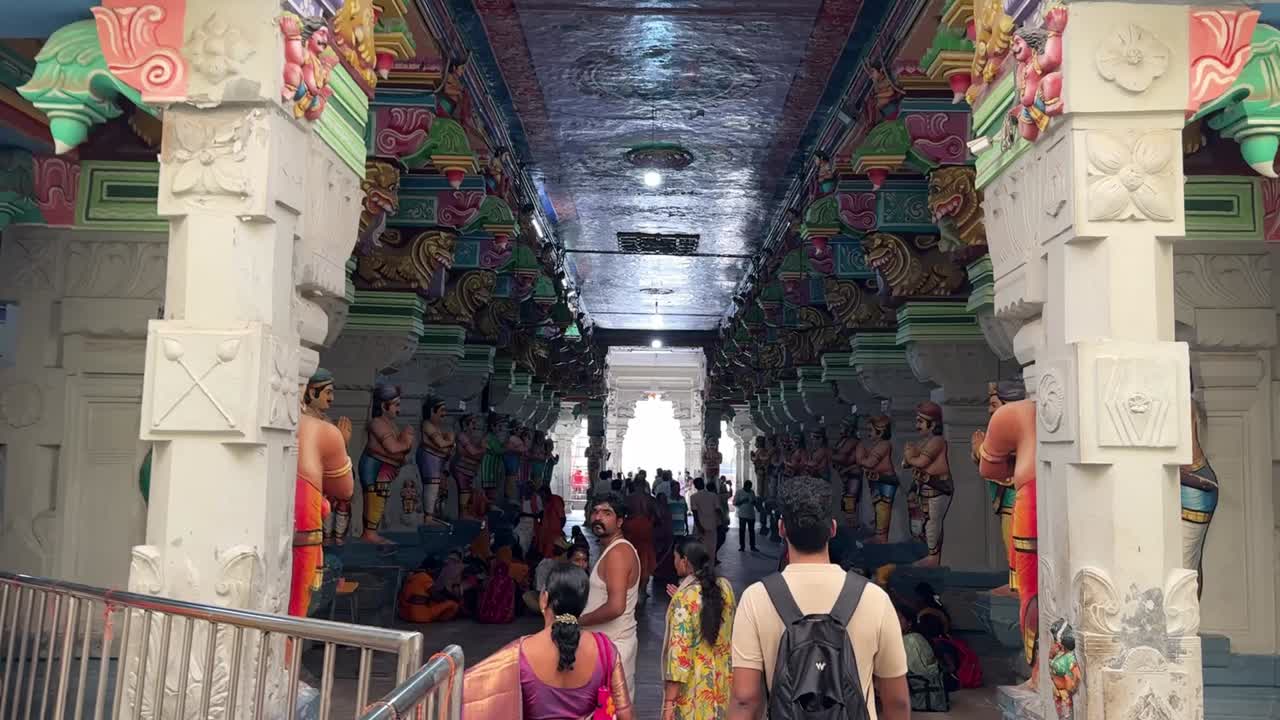 Handheld shot of Rameshwaram temple with people walking through this beautiful place.