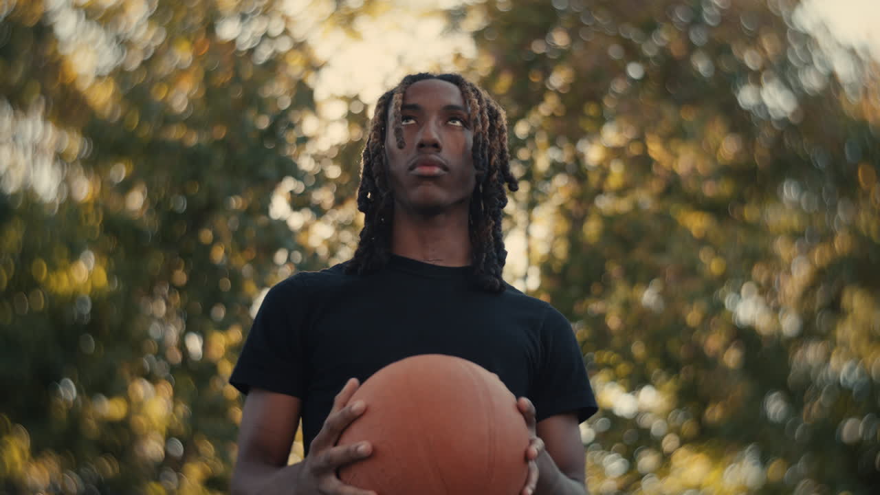 Young Man Holding a Basketball