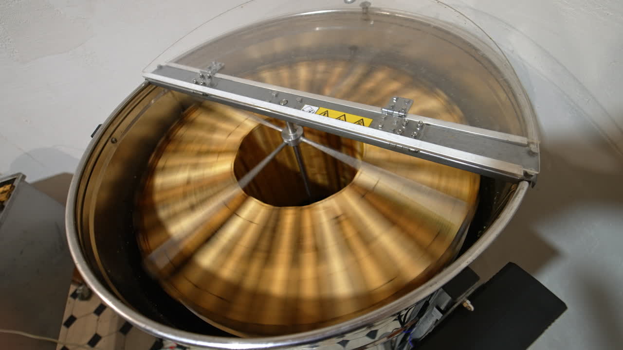 Honey extraction in the electric machine working in the apiary. Apparatus rotating frames to gather honey harvest. Top view.