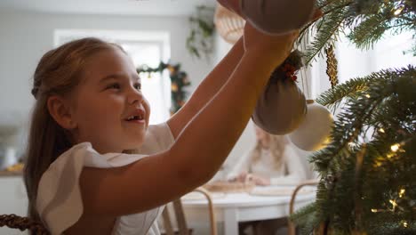 father and daughter decorating the christmas tree