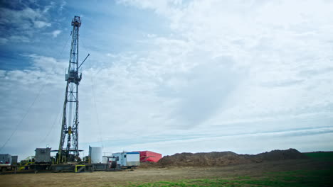 the site for oil or gas production. high metal tower for drilling the minerals. low angle view.