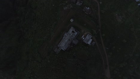 cinematic drone shot - zoom out shot of a abandoned tea factory