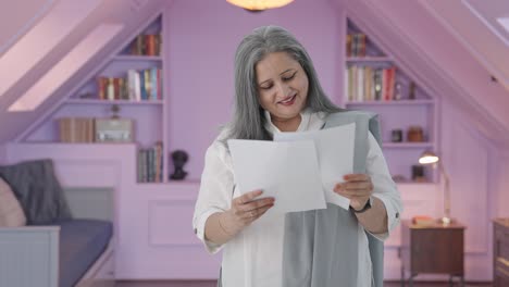 Happy-Old-indian-woman-reading-reports