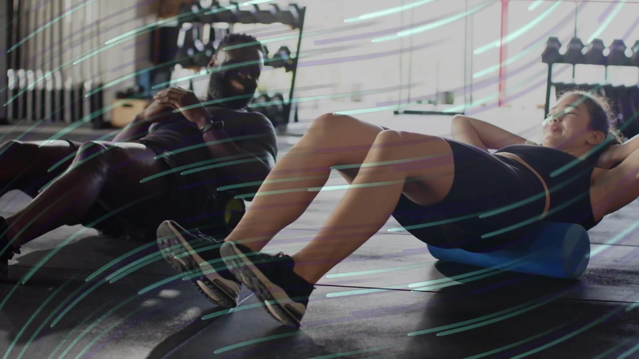 Woman starting foam roller crunches, man adjusting ball, animated streaks showing fitness mobility