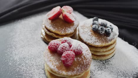 video of pancakes with fruit on white plate seeing from above