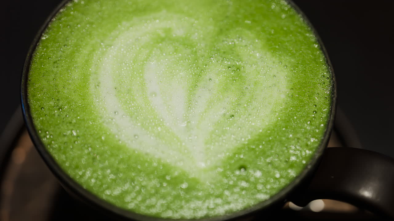 Close up of a matcha latte on a tray at a cafe