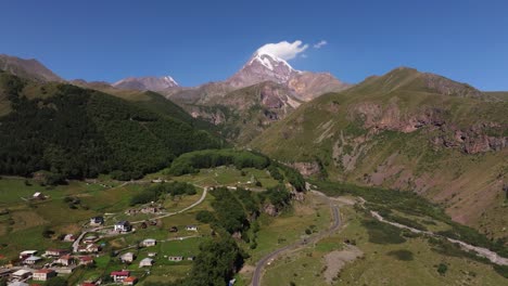 aerial establishing shot above road to mount kazbek, georgia