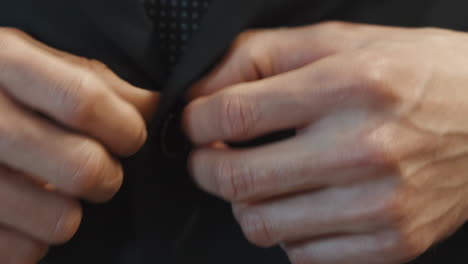 Businessman-buttons-elegant-black-jacket-extreme-closeup