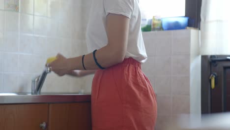 trucking shot of a woman placing peeled potatoes on a cutting board