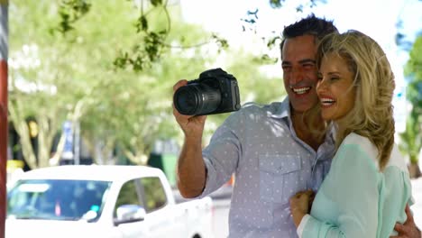 Couple-looking-at-photographs-in-digital-camera