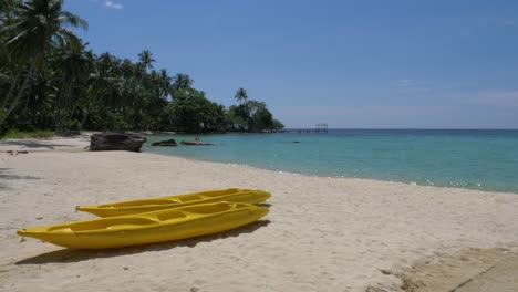 Two-yellow-kayaks-on-a-tropical-beach-on-an-beautiful-island