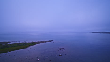 drone shot flying over foggy water to reveal the vastness of lake michigan