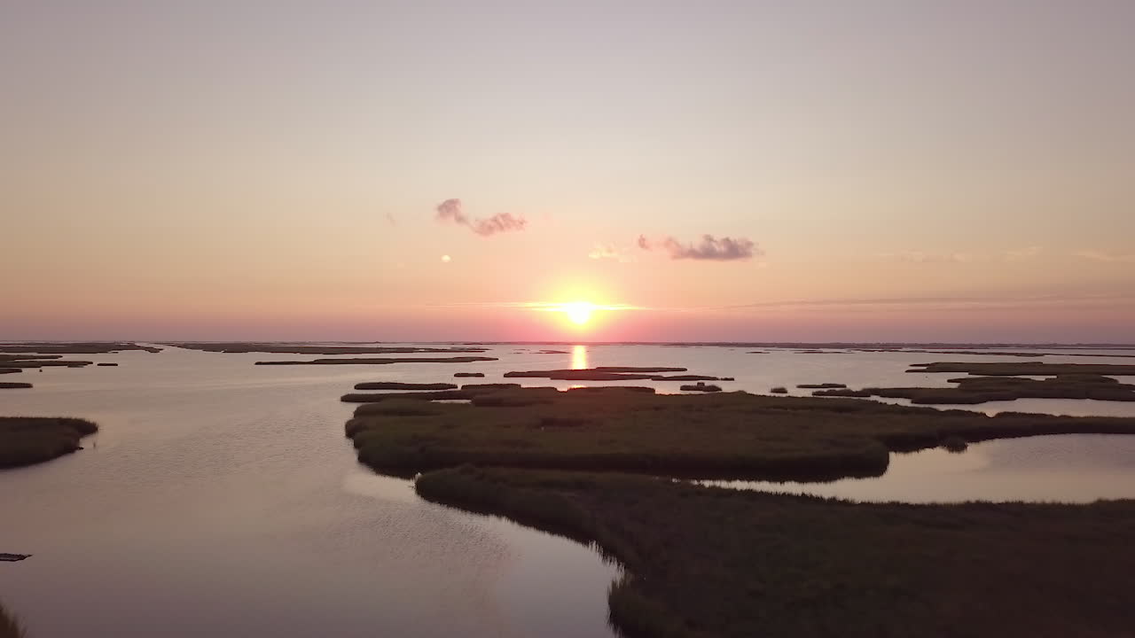 Drone shot of the sun setting over he bayou in Isle de Jean Charles, Louisiana. Fly Over