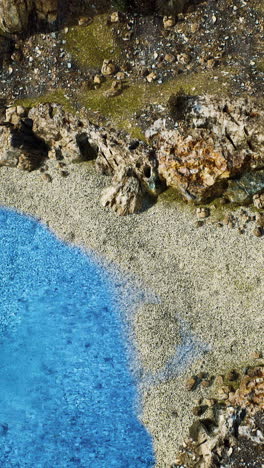 aerial view from flying drone of rocky island in atlantic ocean