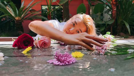 woman interacting with flowers in water