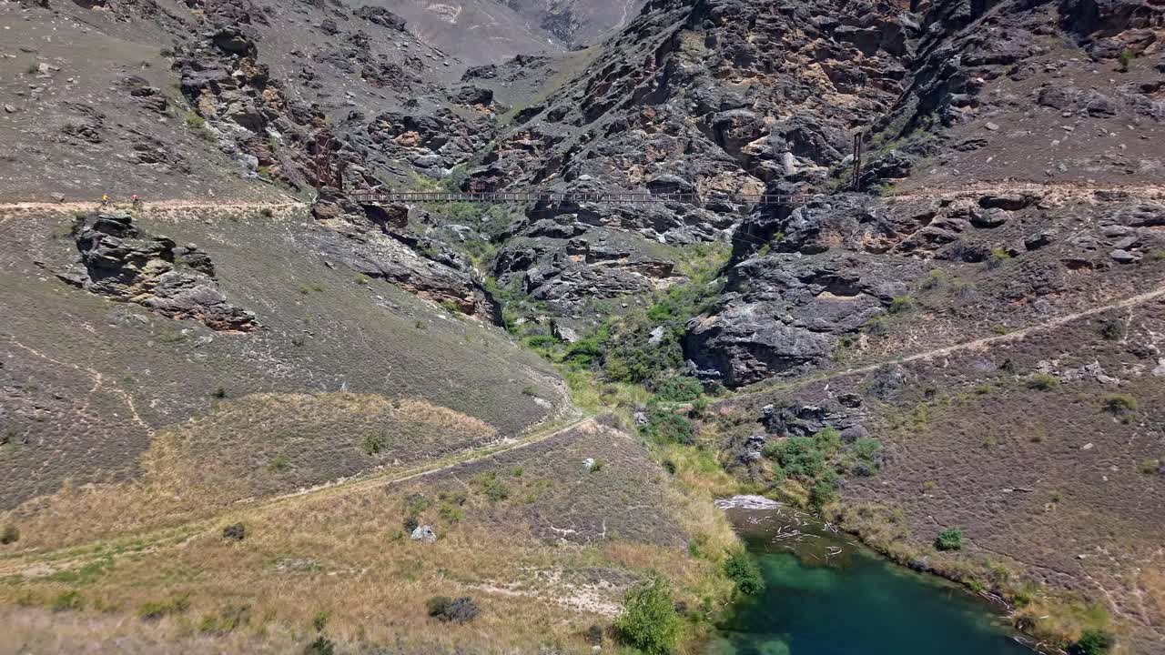 Bridge over rocky landscape on Lake Dunstan trail, ideal for adventure seekers