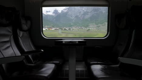 Empty-Leather-business-class-seats---travelling-through-Switzerland-with-train-through-scenic-landscapes