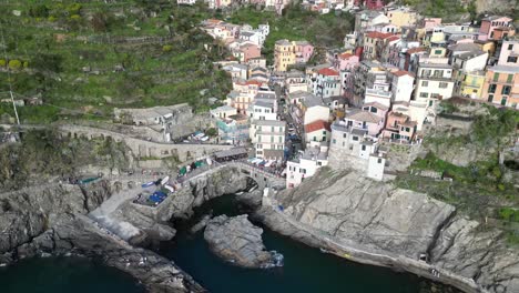 Manarola-Cinque-Terre-Italy-aerial-rotating-overhead-view-of-busy-area-with-tourism