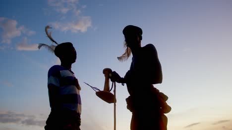 african warriors discuss war strategy during sunset in uganda, africa - close up