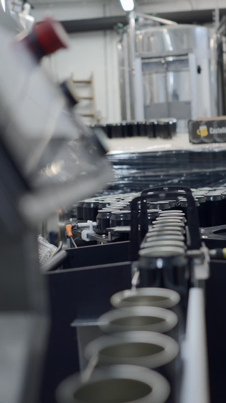 Cans moving along an industrial production line in a factory