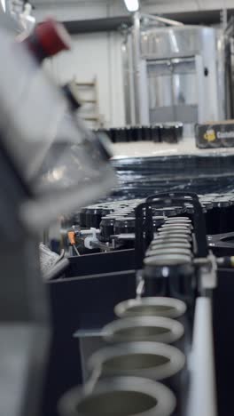cans moving along an industrial production line in a factory