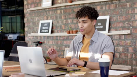 On video call, Working on laptop, man discussing interior design project in modern office