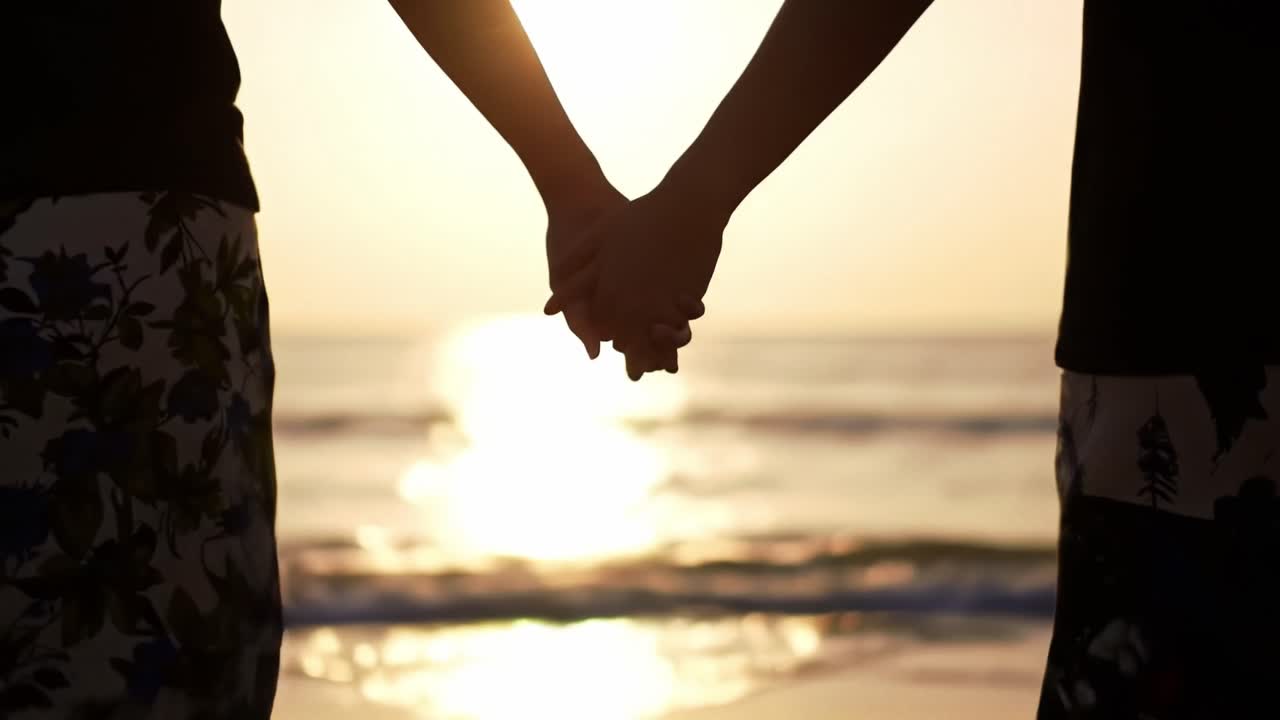 Couples enjoy a romantic sunset by the beach while holding hands and sharing a moment of connection
