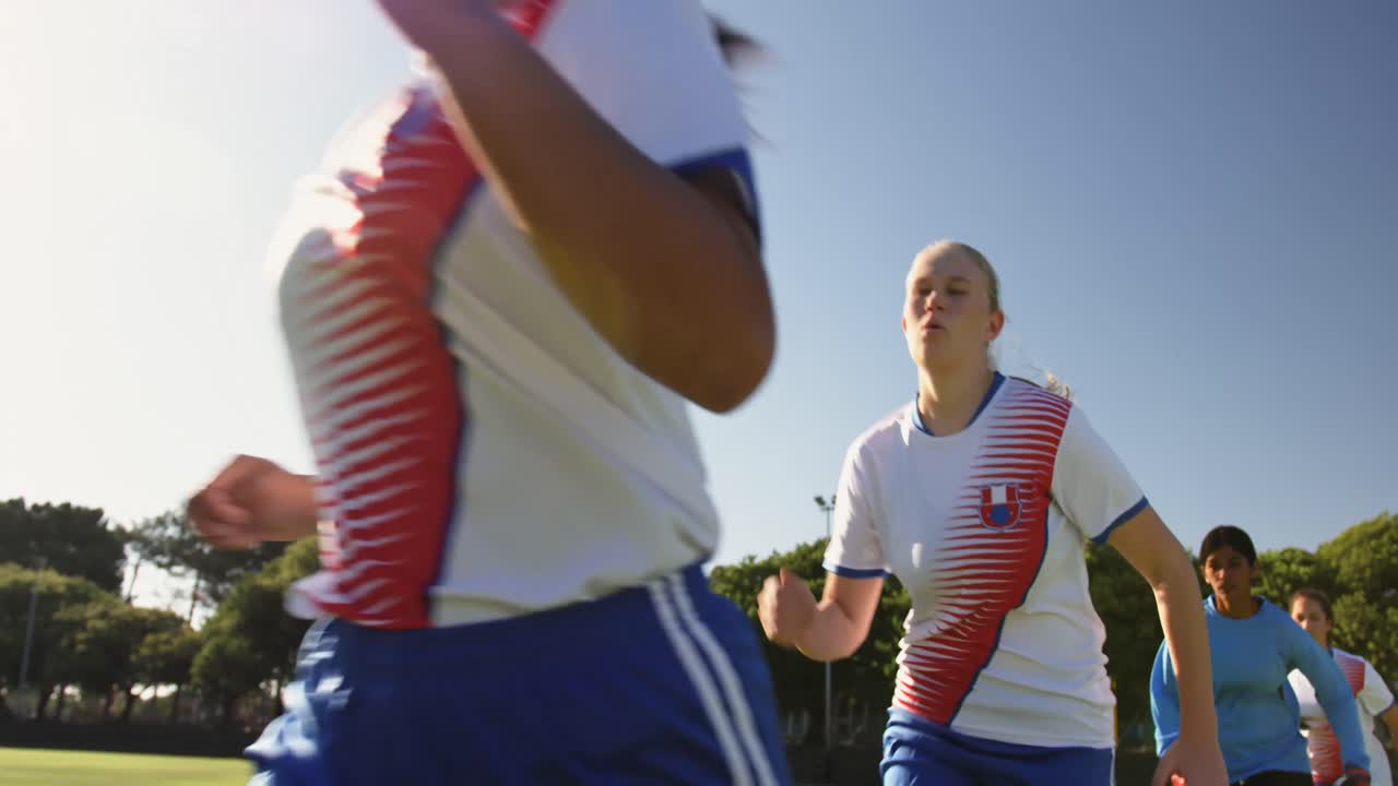 Female soccer team running behind each other. 4k