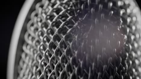 an intricate close-up of a microphone's mesh structure: exploring the textural details and reflections that define high-quality sound equipment