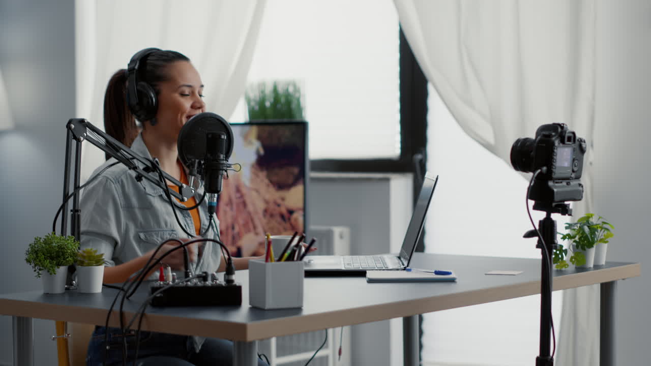 Internet live radio show host typing on computer while talking to audience