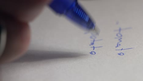 extreme closeup shot of male hand taking notes on paper