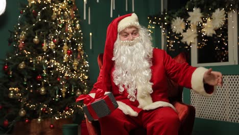 santa sits by a decorated tree holding a gift embodying joy santa claus sits in a cozy chair surrounded by a festive christmas tree full of lights he holds a wrapped gift embodying holiday joy