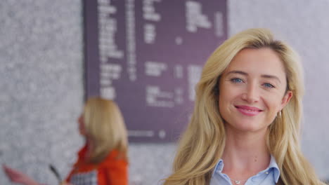 portrait of smiling female owner or worker in coffee shop