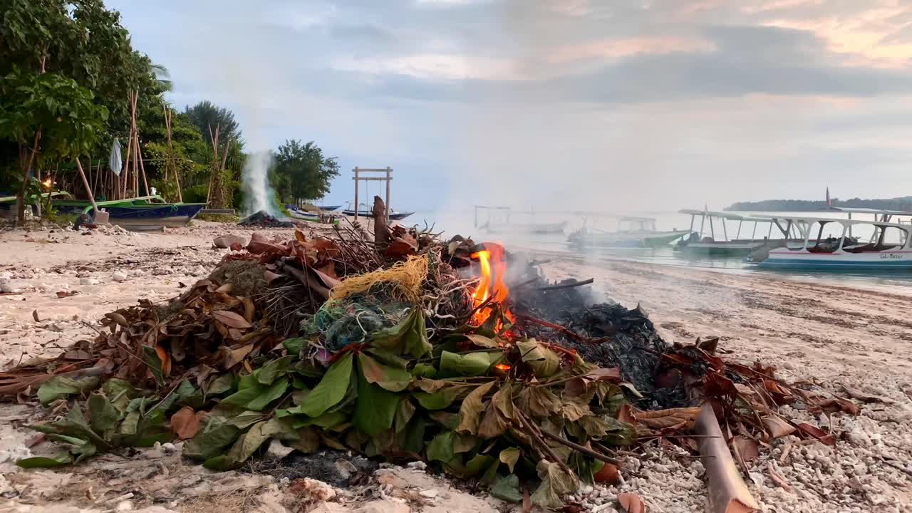 Burning Plastic Trash and dumped Garbage On beautiful beach on Gili Air Island