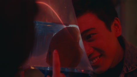 young man looking at fish in a plastic bag