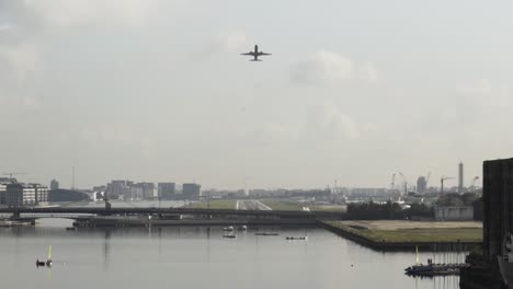 airplane landing over city and river